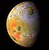 Enhanced-color Galileo image showing a dark spot (just lower-left of center, interrupting the red ring of short-chain sulfur allotropes deposited by Pele) produced by a major eruption at Pillan Patera in 1997 PIA01667-Io's Pele Hemisphere After Pillan Changes.jpg