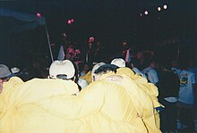 An enthusiastic group of overseas attendees at the Tuesday night barbecue and party, as The Kingsmen play on stage in 1997 SCO Forum 1997 The Kingsmen performing at Cowell College.jpg