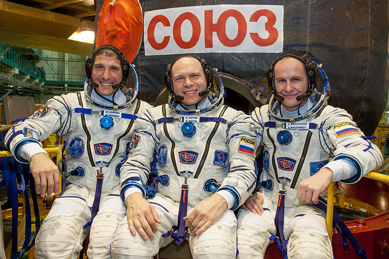 File:Soyuz TMA-10M crew in front of their spacecraft.jpg