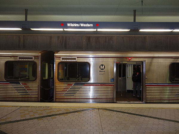 A train is parked at the Wilshire/Western station platform