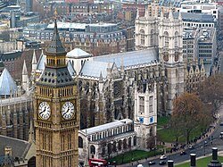 An aerial view of three Grade I listed buildings in Westminster: The Palace of Westminster, Westminster Abbey and St Margaret's Church, which together comprise a UNESCO World Heritage Site. Westminsterabbeyfromeye.jpg