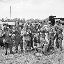 Members of 12th Parachute Battalion enjoy a cup of tea after fighting their way back to Allied lines after three days behind enemy lines, 10 June 1944. 12th Parachute Battalion.jpg