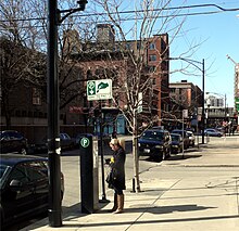 A Chicagoan pays at a pay box 20110219 70 Parking her car, Superior St. near Wells St. (5504193039).jpg