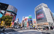 Shibuya Crossing in Shibuya, also known as "the Times Square of the Orient", attracts many tourists. 2018 Shibuya Crossing.jpg