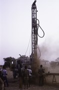 Men drilling a well, Mossi Plateau, Burkina Faso, 1981.