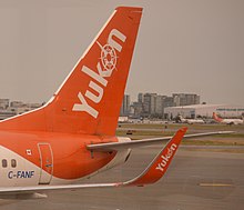 Tails on Air North airplanes are painted orange with a "Yukon" wordmark. The design is also used on the plane's winglets (if present). AirNorth737-500TailAndWinglets.jpg