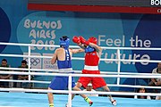 Deutsch: Boxen bei den Olympischen Jugendspielen 2018 Tag 12, 18. Oktober 2018 - Finale im Leichten Weltergewicht Jungen – Ilia Popov (Russland, rot) schlägt Talgat Shaiken (Kasachstan, blau) 4-1; Ringrichter ist James Beckles (Trinidad und Tobago). English: Boxing at the 2018 Summer Youth Olympics on 18 October 2018 – Final Light Welterweight Boys Bout - Ilia Popov (Rusia, rojo) supera a Talgat Shaiken (Kazajstán, azul) 4-1; Referee is James Beckles (Trinidad and Tobago). Español: Boxeo en los Juegos Olímpicos Juveniles de Verano de 2018 en 18 de octubre de 2018 - Chicos de peso welter ligero final: Ilia Popov (Uzbekistán, roja) le gana a Talgat Shaiken (Egipto, azul) 4-1; El árbitro es James Beckles (Trinidad y Tobago).