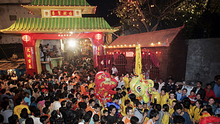 Large crowd in front of a colorful stage