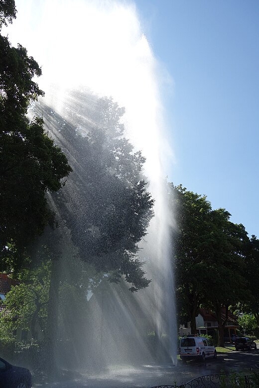 Water escapes at high speed from a damaged hydrant that contains water at high pressure