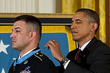 Friends of Army Sgt. 1st Class Leroy Arthur Petry inspect the Medal of  Honor he received at the White House.