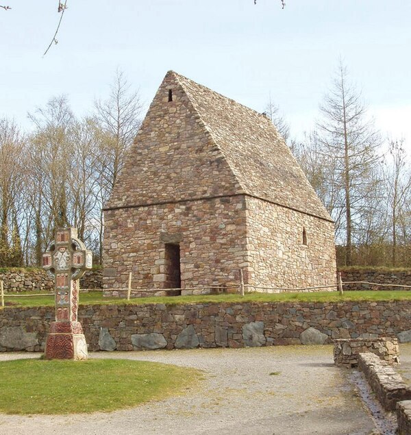 A reconstruction of an early Irish Christian chapel and high cross