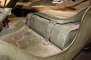 Fuel tank positioned under driver seat, inside tub
