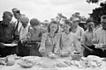 Russell Lee. Helping the plates at dinner on the grounds at all day community sing. Pie Town, New Mexico. June 1940.