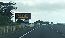 A traffic management sign in Paraparaumu indicating COVID-19 alert level 3 in April 2020 Highway sign under 'Alert Level 3'.jpg