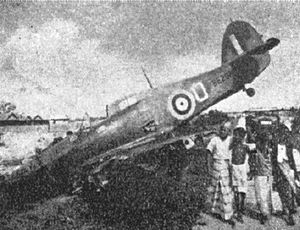 Crashed aeroplane with onlookers