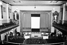 Interior of the auditorium, proscenium arch, horseshoe mezzanine, wall murals and Wurlitzer organ. Pictured 1929. Interior of the Odeon Theatre auditorium and Wurlitzer organ, Hobart, Tasmania in 1929.jpg