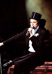Madonna, dressed as a Victorian gentleman, performs "Bye Bye Baby" on The Girlie Show World Tour in 1993 LikeAVirginUnderGround (cropped).jpg