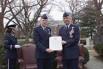 Lt. Gen. Ronald C. Marcotte (right), is presented his formal retirement certificate by Gen. John W. Handy (left), during his retirement ceremony held at Heritage Park on 8 March 2002.