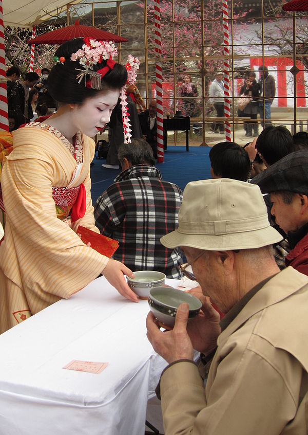 A maiko serving tea at the plum blossom festival.