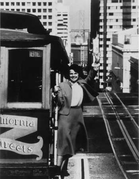 Feinstein riding a cable car in San Francisco during her tenure as mayor, c.1978–1988