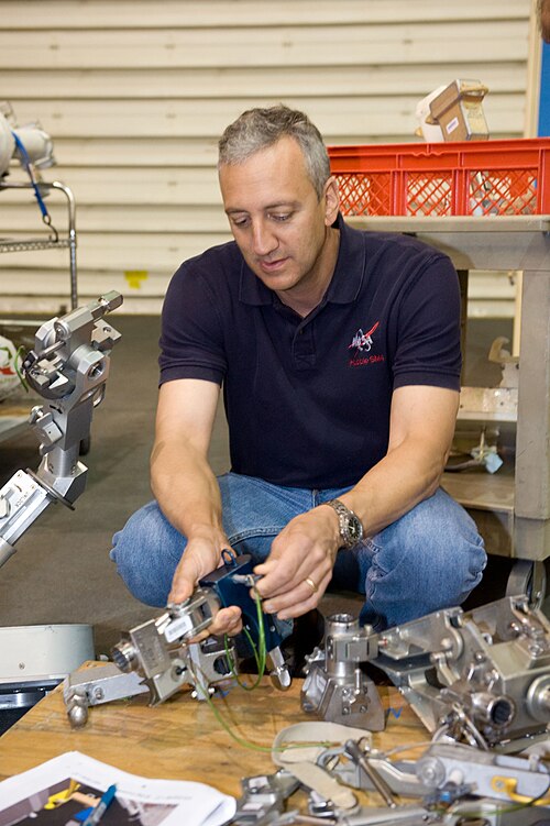 Massimino works with EVA hardware while training for STS-125