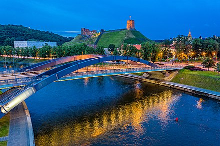 Neris River at Mindaugas Bridge with Vilnius Upper Castle in the distance. A favorable geographic location made the Upper Castle on the Gediminas' Hill unconquerable for hundreds of years.[30]