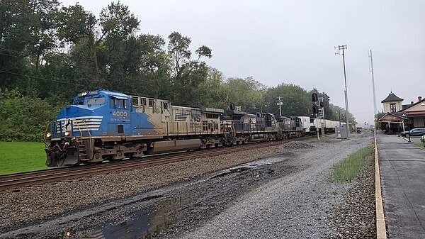 A trio of GE AC44C6Ms lead an eastbound intermodal at Lewistown station in 2021