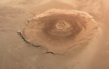 Picture of the largest volcano on Mars, Olympus Mons. It is approximately 550 km (340 mi) across. Olympus Mons - ESA Mars Express - Flickr - Andrea Luck.png