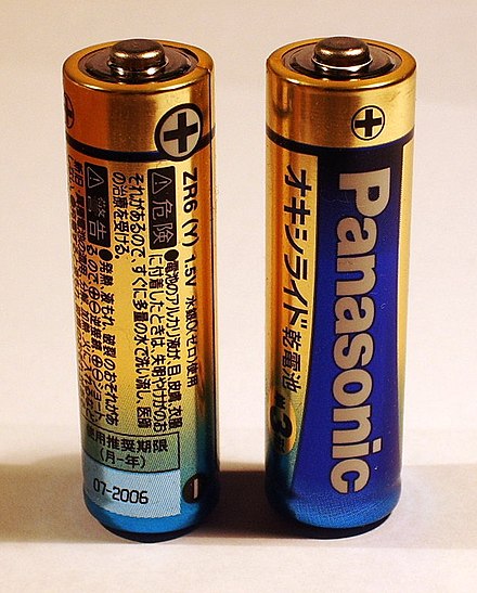A pair of AA cells. The + sign indicates the polarity of the potential difference between the battery terminals.