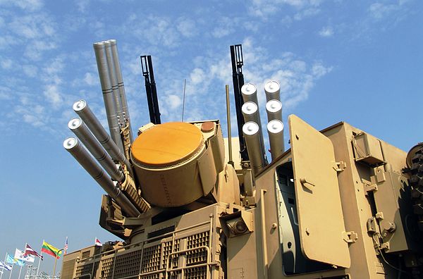 The Pantsir-S1 Weapon System. In the centre is the EHF phased-array tracking radar. Two twin-barrel 2A38M automatic anti-aircraft guns and 12 ready to