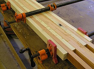 Pipe clamps being used to glue up a wooden lamination Pipe clamp 1.jpg