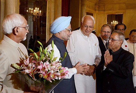 Farooq Abdullah stands between Prime Minister Manmohan Singh and President of India Pranab Mukherjee with Vice President of India Mohammad Hamid Ansari on far left at the Presidential Palace in New Delhi, India in 2013.