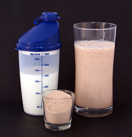 Protein milkshakes, made from protein powder (center) and milk (left), are a common bodybuilding supplement