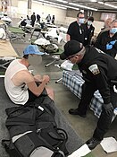 Colorado Ranger helping a disaster victim in a shelter. Rangers support with a shelter.jpg