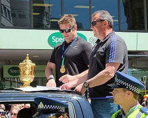Richie McCaw signing autograph next to Webb Ellis Cup and Ian Foster (2015 RWC All Blacks victory parade in Wellington).jpg