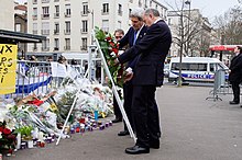 US Secretary of State John Kerry and French Foreign Minister Laurent Fabius laying wreaths outside the scene Secretary Kerry and French Foreign Minister Fabius Straighten the Ribbons on a Wreath They Laid at Hyper Cacher Kosher Grocery Store in Paris (16104894220).jpg