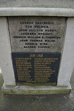 A rectangular granite panel a list of names and a small back panel attached to it with the title "1939-1945" above more names.