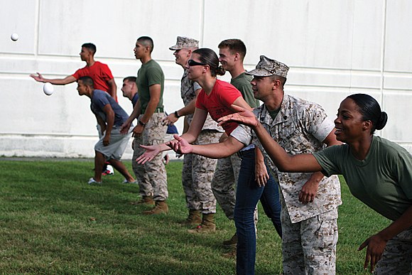 U.S. Marines and sailors participate in an egg-toss competition at the Commissary Commando competition held at the Camp Foster commissary