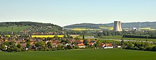 View from the Ohrbergpark to the small village Tundern and to the Grohnde Nuclear Power Plant beside the river Weser in the Upper Weser Valley and the Weser Uplands. The yellow fields are rapeseed fields. Upper Weser Valley with the Grohnde nuclear power plant.JPG