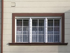 Muntins divide each window into six panes of glass. Two rounded mullions separate each casement window, in Novy Bor, the Czech Republic. Windows in Novy Bor 200.jpg