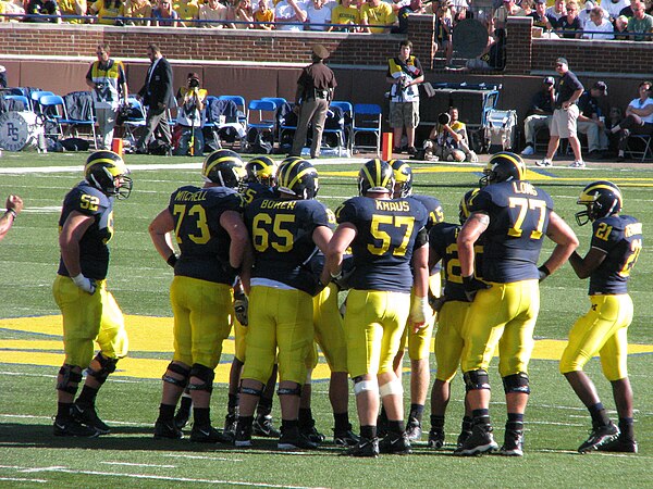 Adam Kraus (57) and Jake Long (77) obscure Ryan Mallett (15) and Mike Hart (20), while Boren (65) looks on.