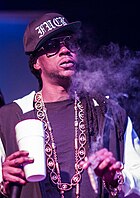 2 Chainz appears on the lead single "Double Tap" with a guest rap verse. 2 Chainz 2013.JPG