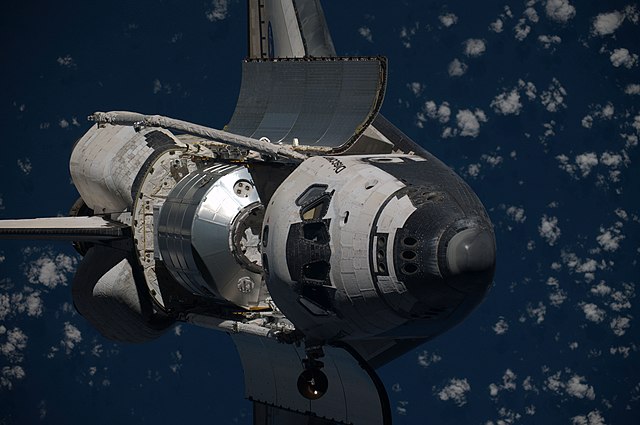 Discovery approaches the ISS with Leonardo in its payload bay