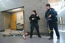 Ramsey County, Minnesota law enforcement officers next to a simulated casualty during an active shooter response exercise at the Arden Hills Army Training Site Active Shooter Exercise Aims to Strengthen Response 160401-Z-BC699-164.jpg