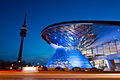 BMW Welt with the Olympiaturm observation tower, dusk.