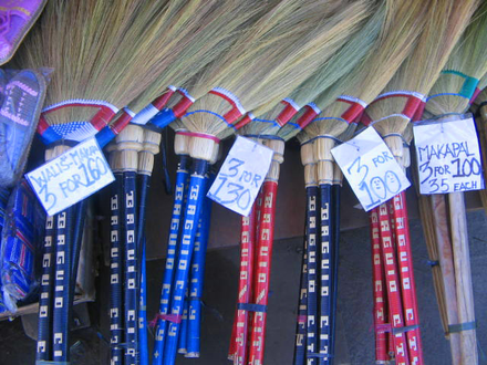 Brooms with price tags being sold in market