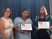 Sandy Pitcher presenting the CCSA's 2015 Jill Hudson Award to sisters Karina and Rose Lester