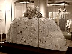 [124]"Mantua gown made from an ivory silk brocaded in a pattern of stylised flowers and leaves."