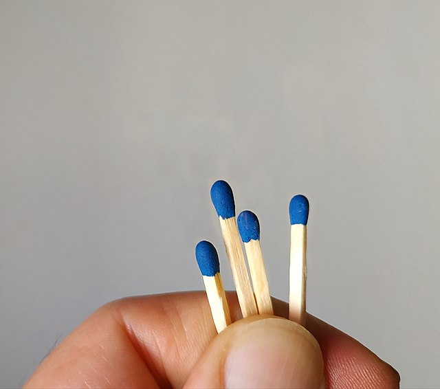 Drawing straws within a small group: one of four matches is broken to be shorter than the others, and the four are presented to the group to draw from