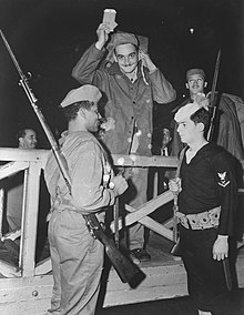 A Brazilian soldier (left) with a Mauser M1908 (or M1908/34), standing in front of an American sailor with a M1903 Springfield rifle. Embarque de primeiro escalao da Forca Expedicionaria Brasileira para a Italia (6).jpg